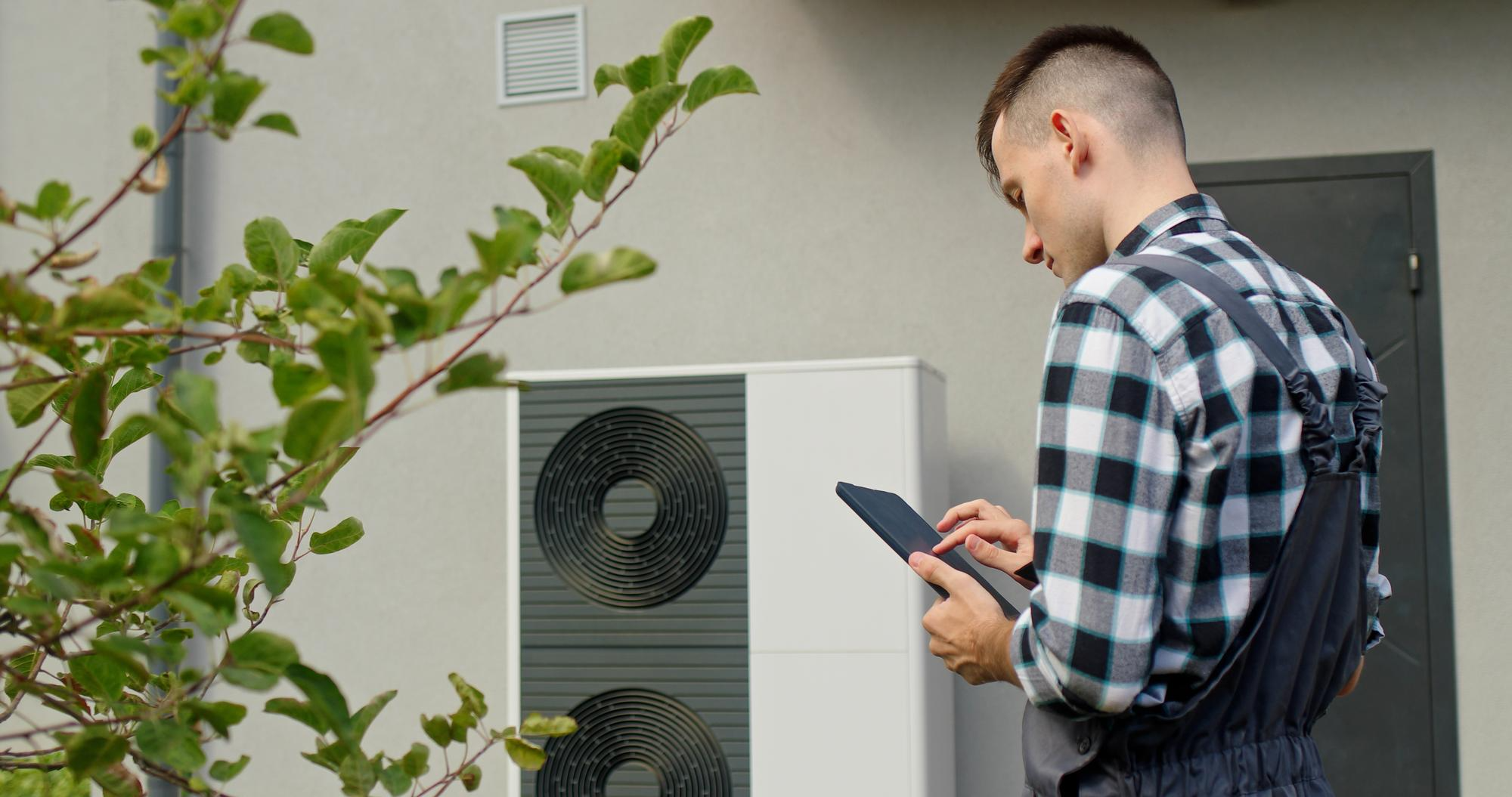 CoolAir technician servicing an outdoor HVAC system