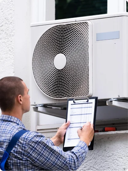 Technician recording an outdoor air conditioning unit inspection