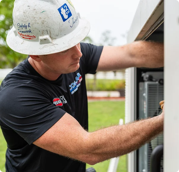 CoolAir HVAC technician servicing an outdoor air conditioning unit.